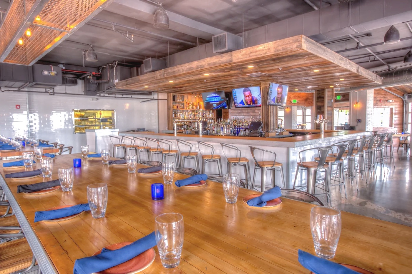 Restaurant and bar interior with a wood canopy over the bar