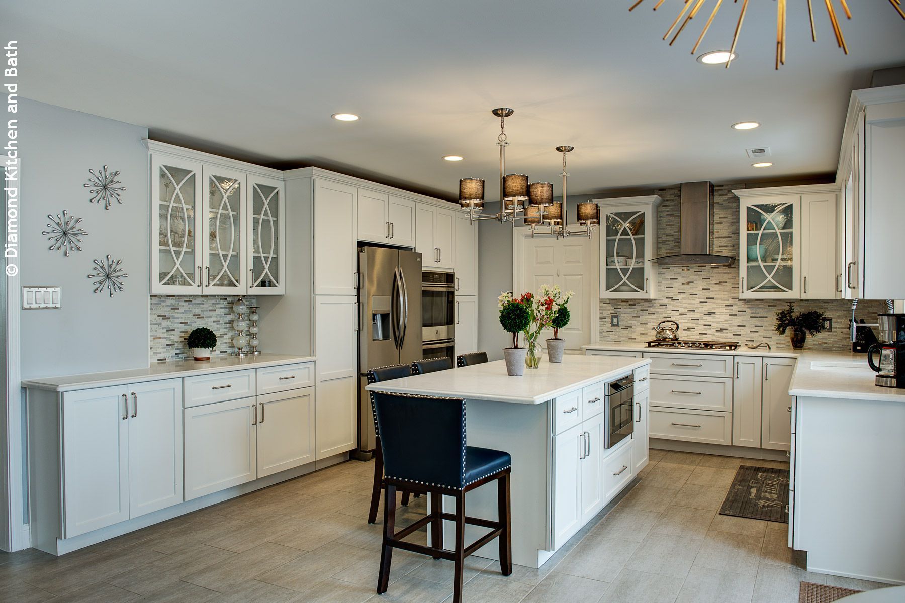 White kitchen with glass-front upper cabinets and large island